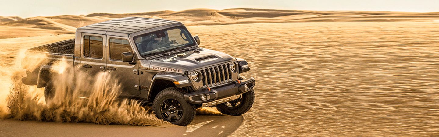 The 2021 Jeep Gladiator Mojave being driven on sand.