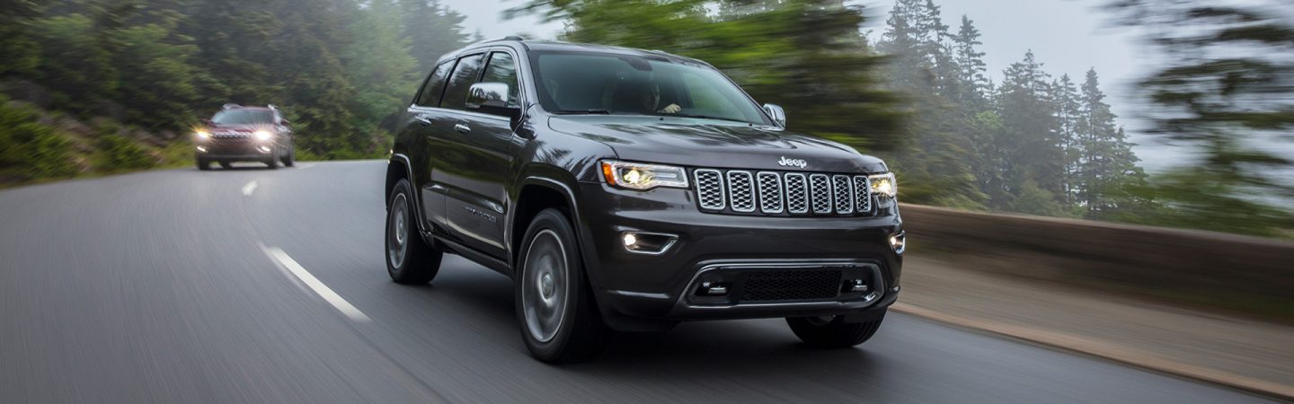 The 2021 Jeep Grand Cherokee Overland being driven on a mountain road.