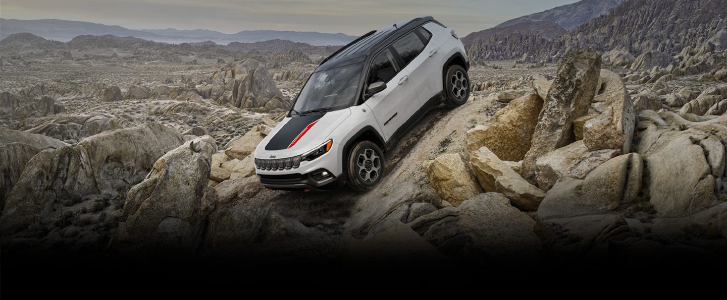 The 2022 Jeep Compass Trailhawk descending a steep, rocky slope.