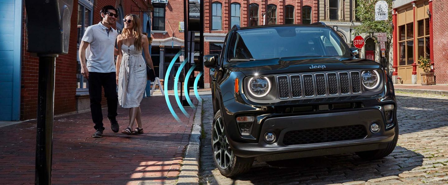 Sensor bars emanating from the door of a 2022 Jeep Renegade Limited intersect with a man and woman approaching the vehicle.