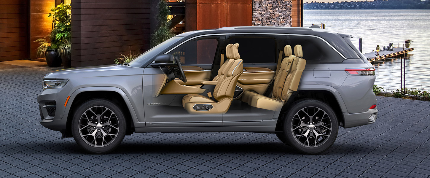 A slider that, begins with an exterior profile view of the two-row 2023 Jeep Grand Cherokee and when pulled back, reveals an interior view of both rows of seats inside.
