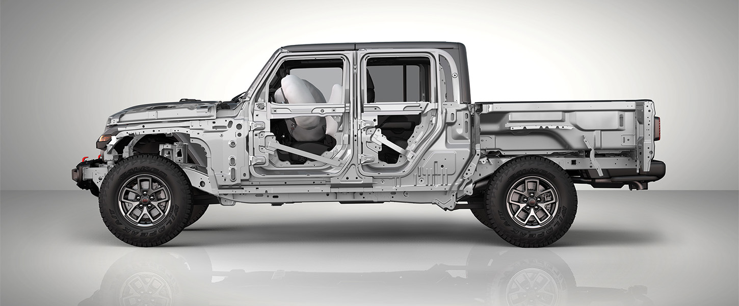 A slider that when pulled to the left reveals an under-the-skin driver-side profile of a 2025 Jeep Gladiator. And when pulled to the right reveals an exterior driver-side profile of a gray 2025 Jeep Gladiator Rubicon X.