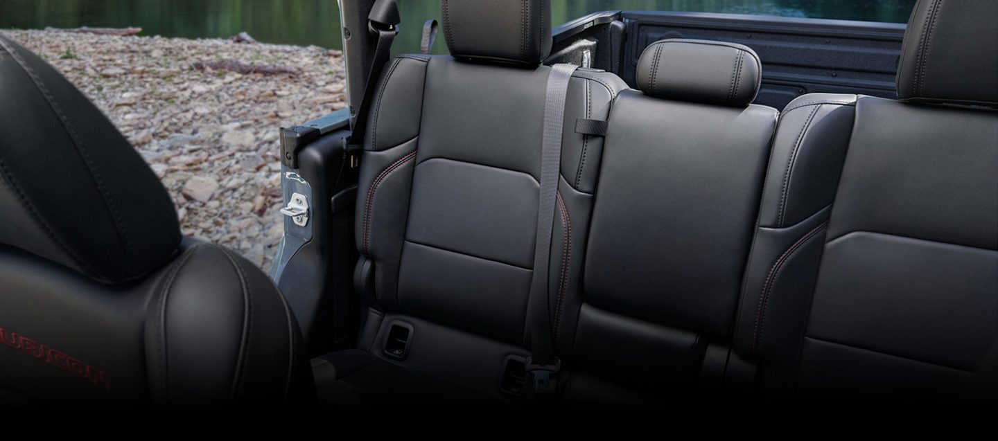 The rear seats in the 2026 Jeep Gladiator Rubicon X with its doors and top removed.