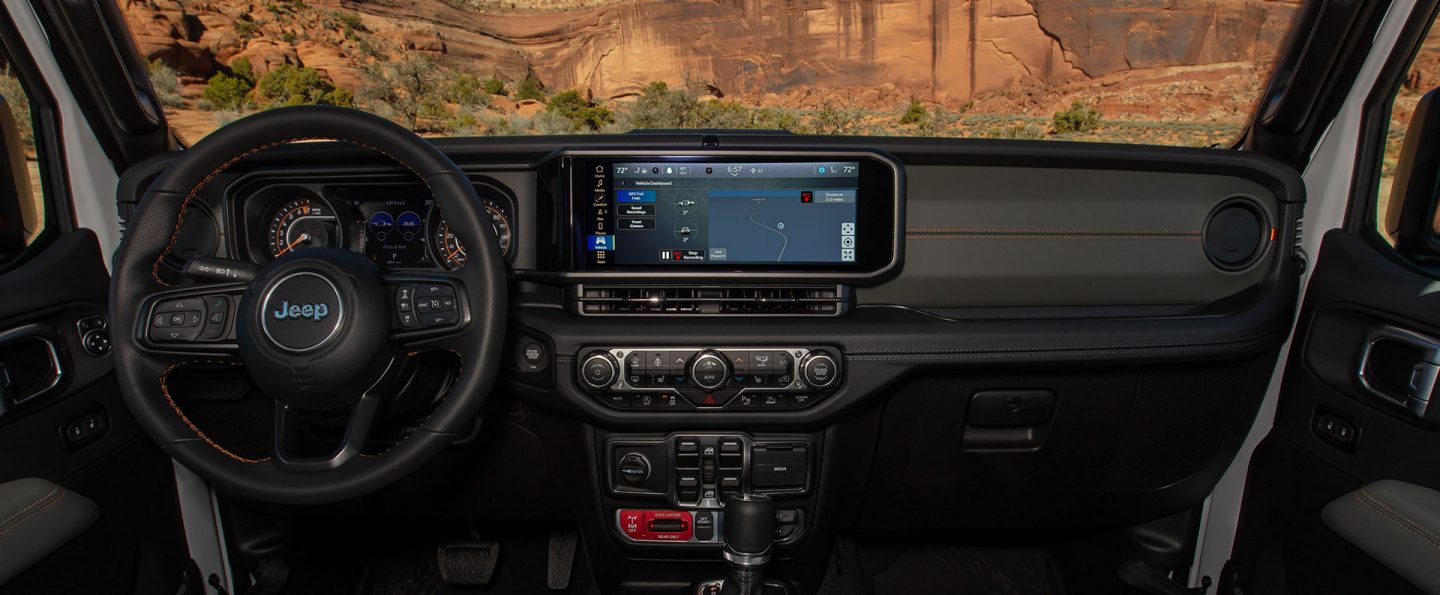 The front row in the 2026 Jeep Gladiator with the Uconnect touchscreen displaying the trail recording screen.