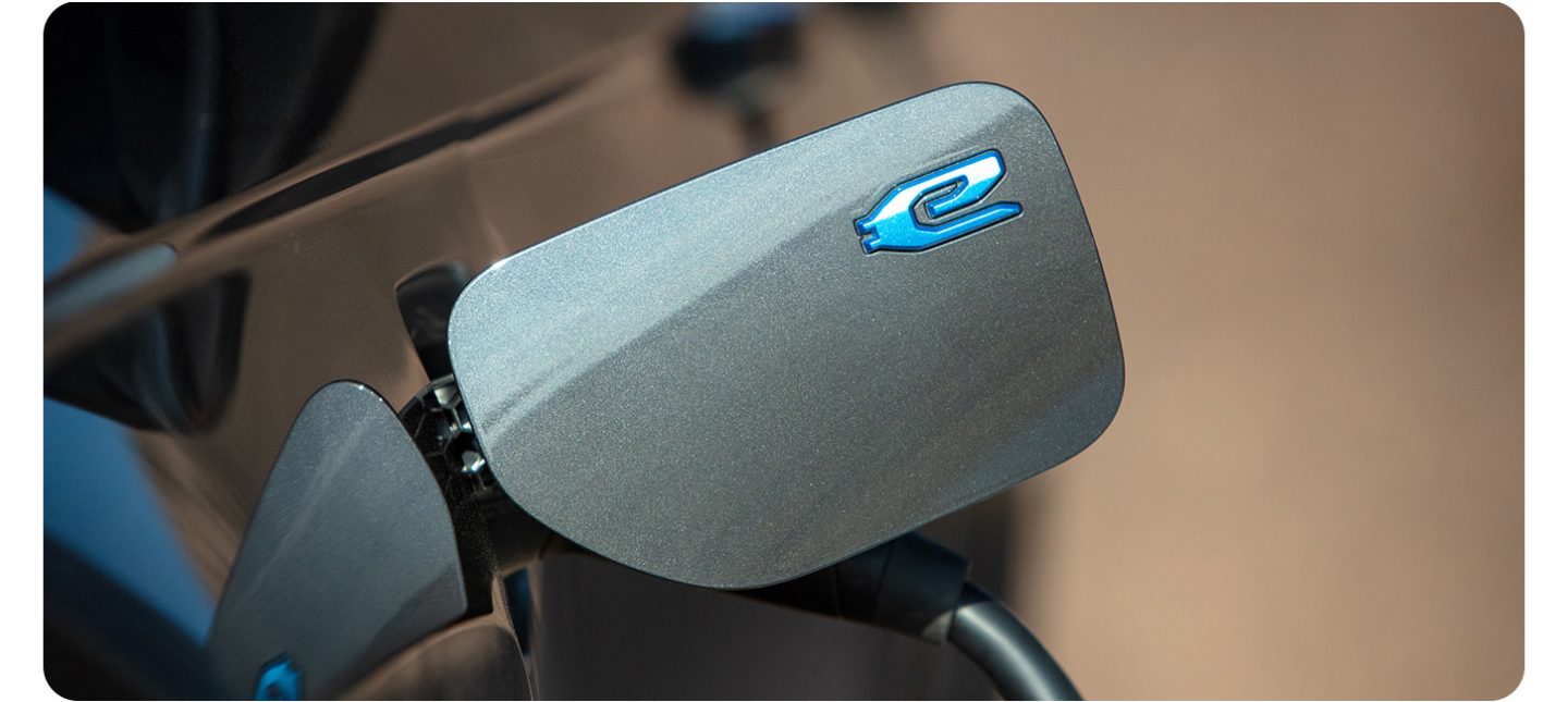 The charging port on the 2026 Jeep Grand Cherokee 4xe with a charging cord plugged in.