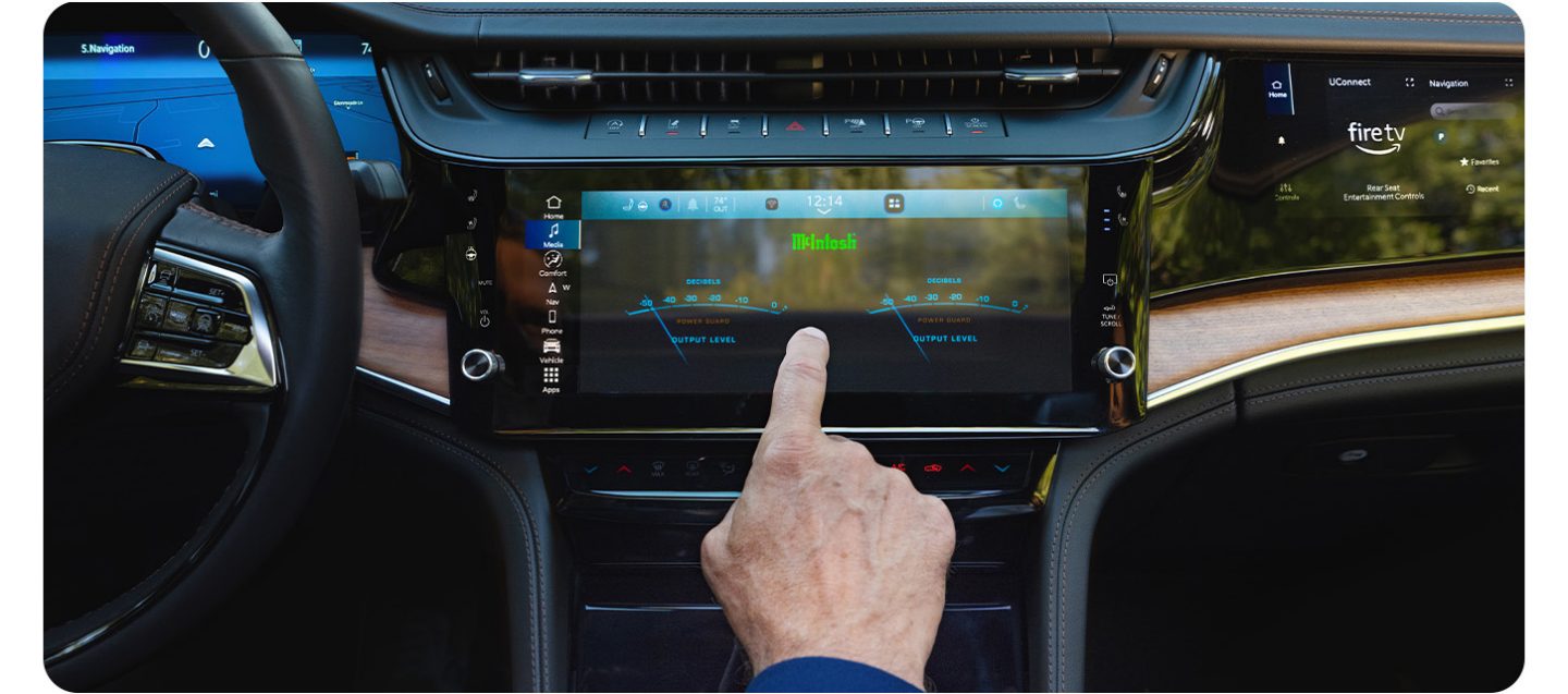 The Uconnect touchscreen in the 2026 Jeep Grand Cherokee Summit displaying a split-screen of radio station settings on the left and climate control settings on the right.