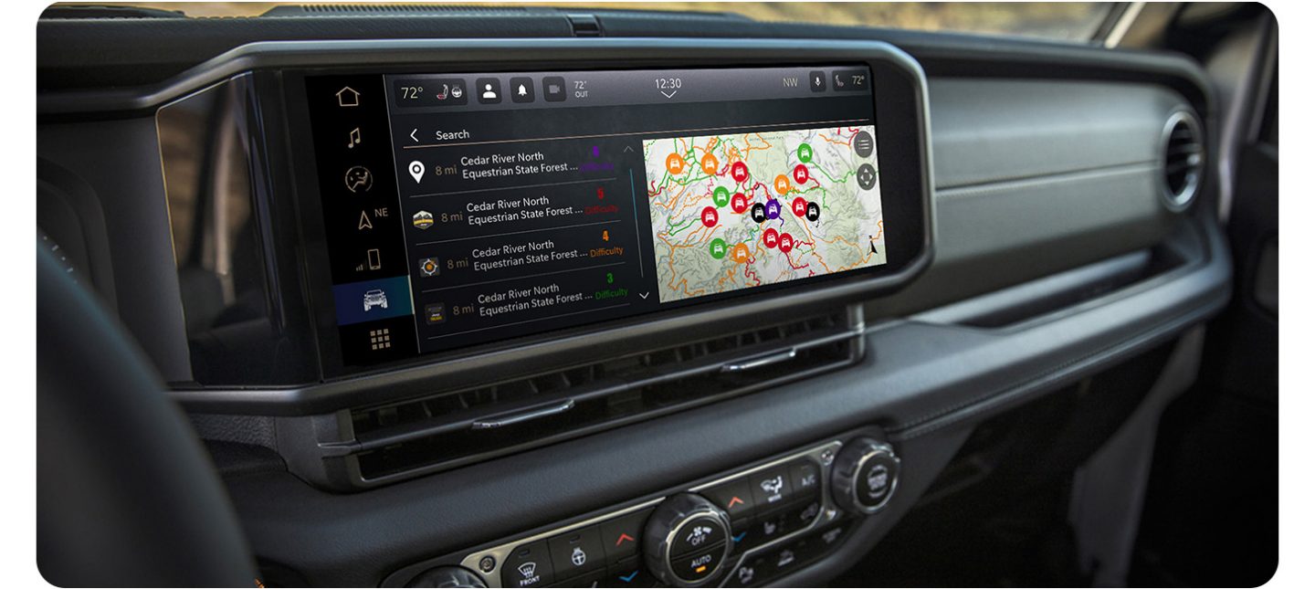 The Uconnect touchscreen in a 2026 Jeep Wrangler displaying a page in the Off-Road Trail Guide from Trails Offroad.