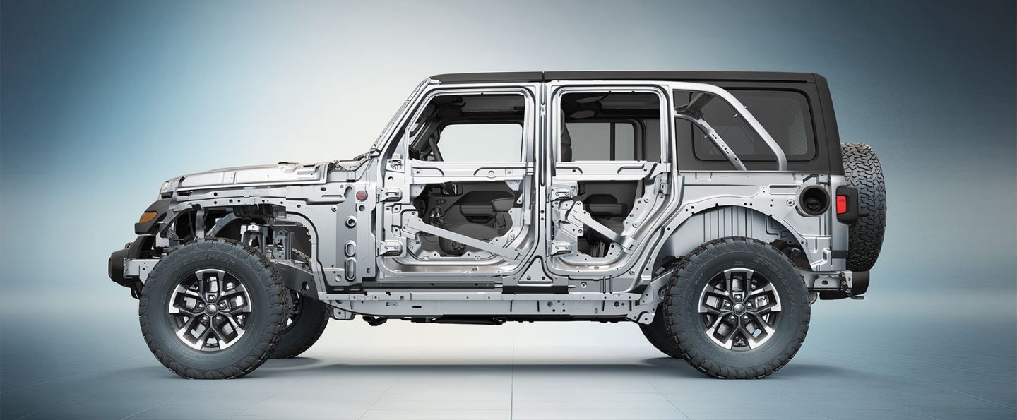 A driver-side profile under-the-skin of the steel frame on a 2026 Jeep Wrangler.