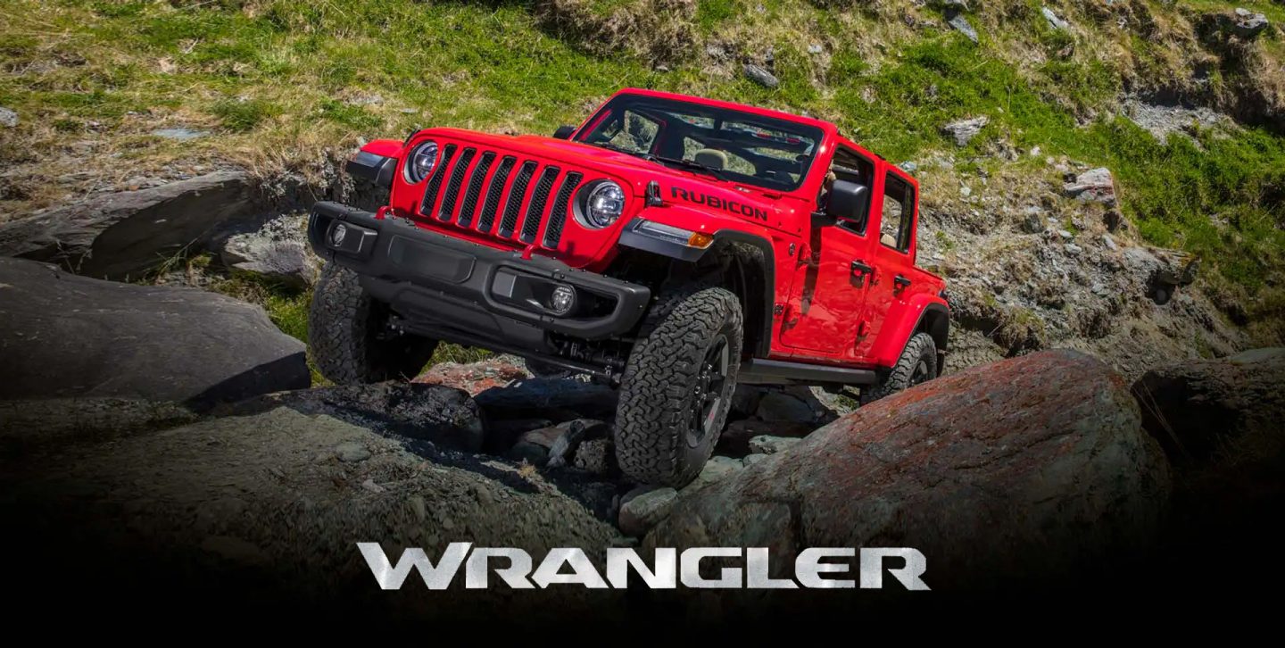 The 2022 Jeep Wrangler Rubicon climbing a steep, rocky slope.