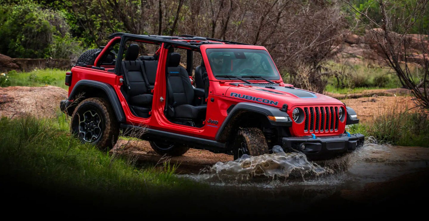 The 2022 Jeep Wrangler Rubicon climbing a steep, rocky slope.