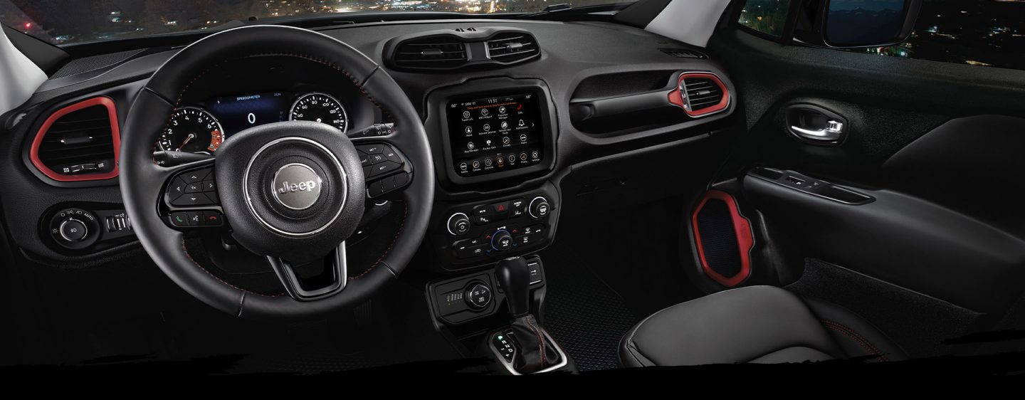 The steering wheel. touchscreen, center console and dashboard in the 2023 Jeep Renegade.