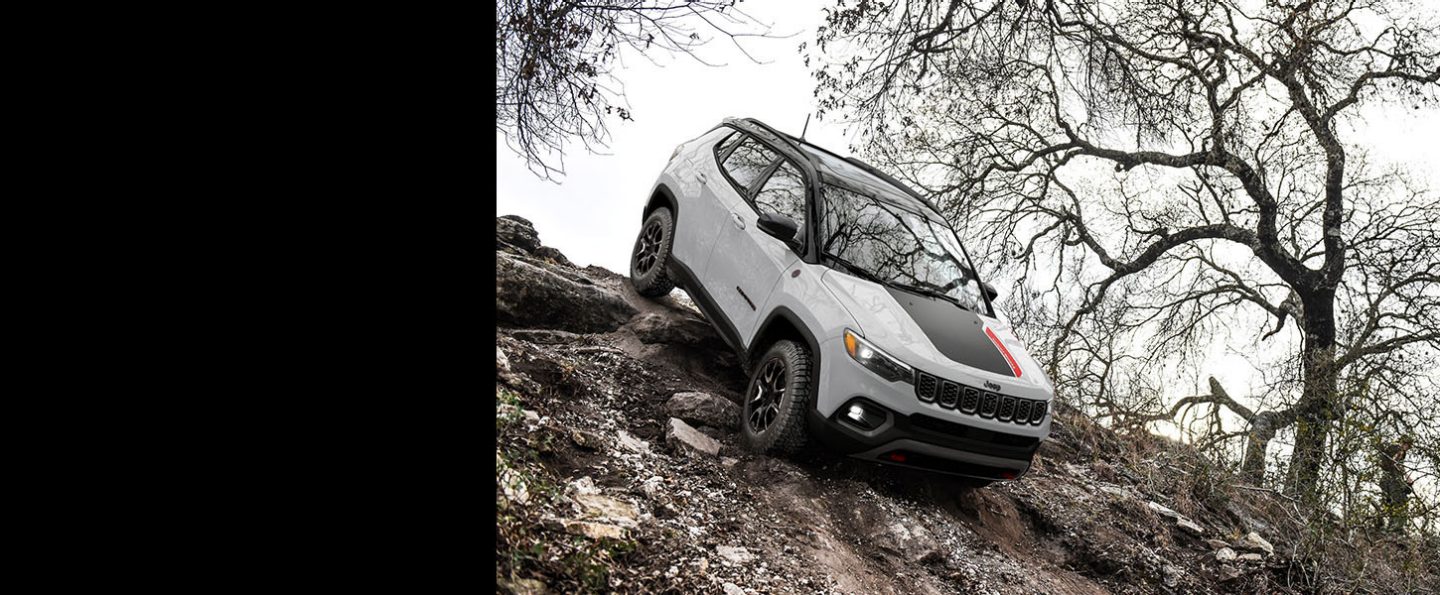 A 2024 Jeep Compass Trailhawk descending a very steep hill off-road.