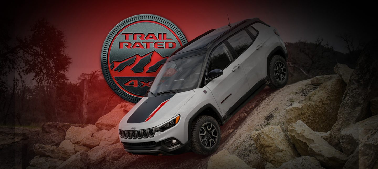 A 2024 Jeep Compass Trailhawk descending a very steep hill off-road. The Trail Rated 4x4 badge.