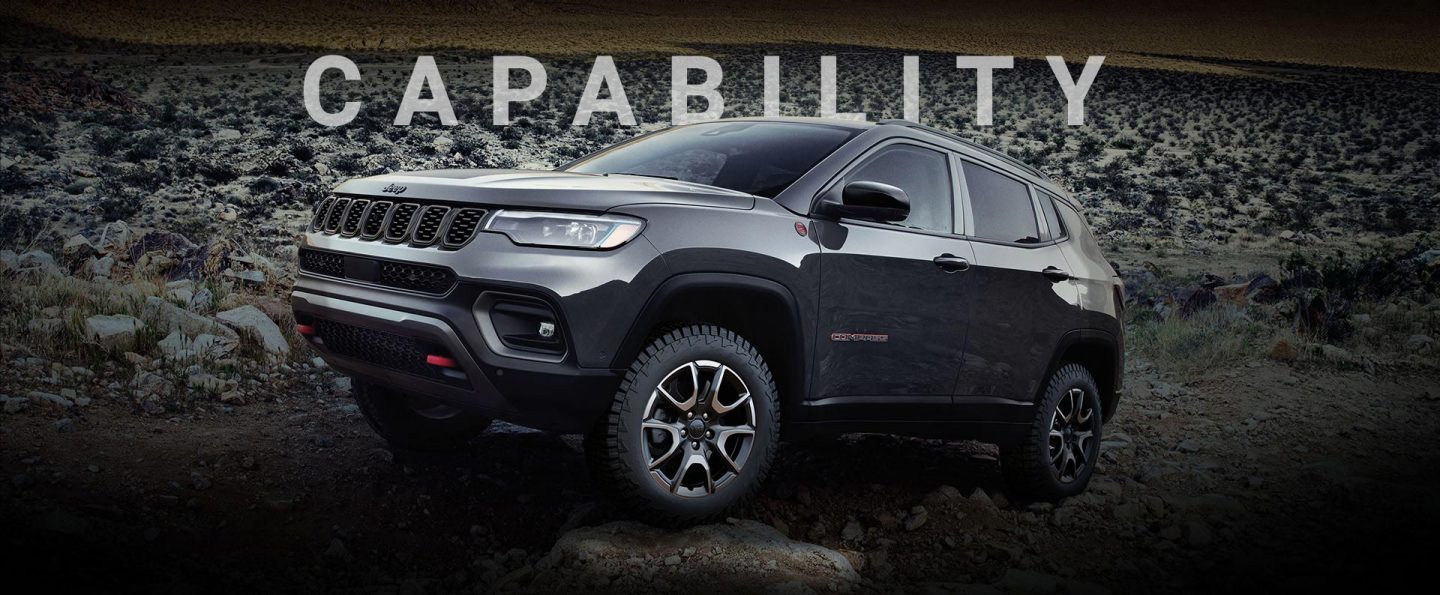 A 2024 Jeep Compass Trailhawk crawling over large and small rocks and stones off-road. Capability.